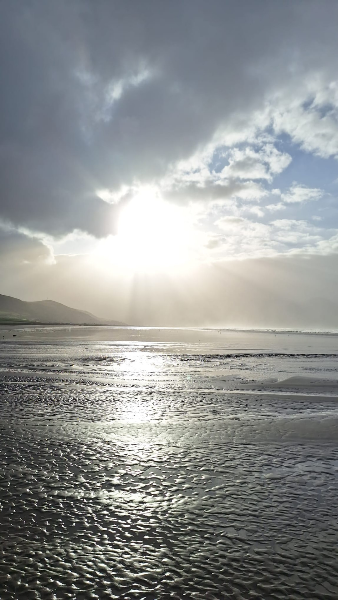 Sunlight breaking through clouds over the coast of County Kerry.